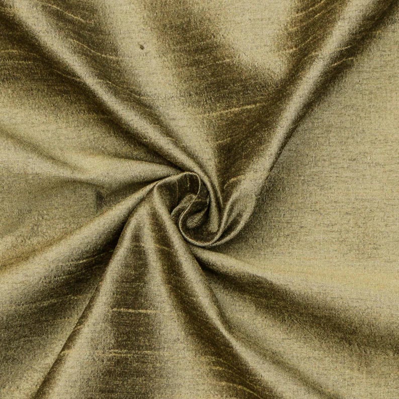 May include: A close-up of a smooth, golden brown fabric with a subtle sheen. The fabric is draped and folded, showcasing its texture and drape.