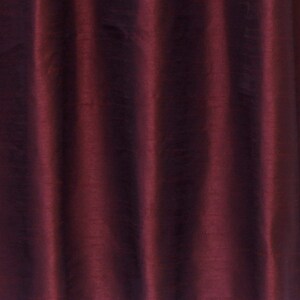 May include: Close-up of a deep burgundy fabric with a subtle sheen. The fabric has a smooth, silky texture and a slightly wrinkled appearance.