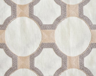 May include: A white fabric with a geometric pattern of overlapping circles and squares in shades of gray and beige.
