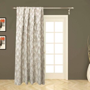 May include: A single beige curtain panel with a white feather pattern. The curtain is hanging from a silver curtain rod.