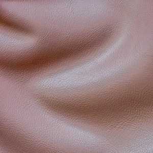 May include: Close-up of a brown leather texture with a subtle sheen. The leather has a pebbled surface and is slightly wrinkled, creating a soft and inviting look.