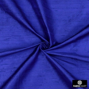 May include: A close-up of a deep blue silk fabric with a subtle sheen. The fabric is folded and draped, showcasing its texture and drape.