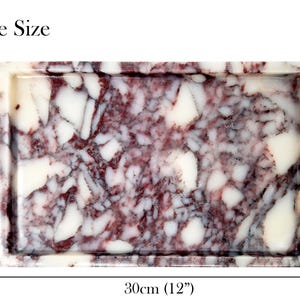May include: Rectangular tray with a marbled pattern in shades of burgundy and white. The tray is 12 inches long and 8 inches wide. The words "Large Size" are at the top.