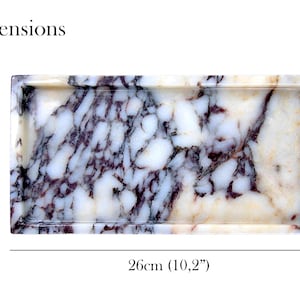 May include: Rectangular marble tray with a white and purple veined pattern. The tray is 10.2 inches long and 5 inches wide. The dimensions are displayed in the image. The tray is a decorative item.