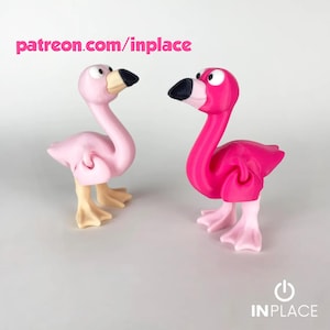 May include: Two flamingo figurines, one light pink and the other hot pink, stand side-by-side. The flamingos have black beaks and tan feet. The text "patreon.com/inplace" is above the figurines. The IN PLACE logo is at the bottom.