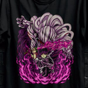 May include: Black t-shirt featuring a vibrant anime-style illustration with purple and pink energy effects. The design includes a character holding a sword. The shirt has the "STITCH AURA" logo and promotional text.