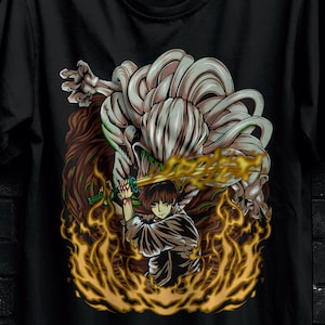 May include: Black t-shirt featuring a detailed anime-style graphic of a character wielding a sword amidst flames. The design includes a large, imposing figure with intricate details. The shirt is hanging on a black hanger.
