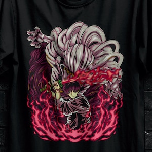 May include: Black t-shirt featuring a vibrant anime-style graphic of a character wielding a sword amidst fiery red and pink energy. The shirt has the "STITCH AURA" logo and promotional text.