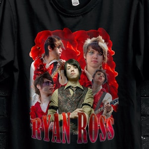 May include: Black t-shirt featuring a graphic of a band with the text "RYAN ROSS" in red. The shirt has a round neckline and short sleeves. The image also includes the "STITCH AURA" logo and a "BULK 50" promotion.