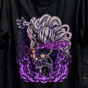 May include: Black t-shirt featuring a purple and white anime-style graphic of a character with a sword and purple energy. The shirt is hanging on a black hanger. The Stitch Aura logo is visible.