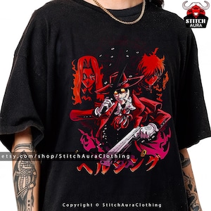 May include: Black t-shirt featuring a vibrant anime-style illustration. The design showcases a character in a red coat and hat, holding a gun, with two other figures in the background. Japanese text is below the central figure.
