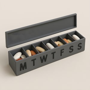 May include: A gray weekly pill organizer with a hinged lid. The organizer is divided into seven compartments, each labeled with a day of the week. Various pills and capsules of different colors are inside the compartments.