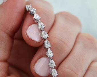 East-West Pear Diamond Tennis Bracelet. 6.5 total carat weight. Available in multiple lengths. Fully customizable