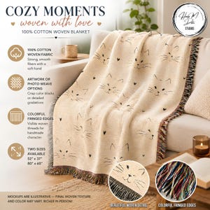 May include: A beige 100% cotton woven blanket featuring a repeating pattern of black cat faces and small hearts. The blanket has colorful fringed edges and is available in 52 inch by 37 inch or 80 inch by 60 inch sizes. The text reads COZY MOMENTS.