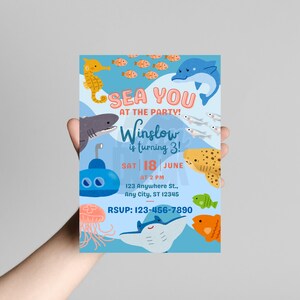 May include: An invitation with a sea theme. The invitation has a light blue background with illustrations of sea creatures like a seahorse, shark, dolphin, and fish. The text reads 'SEA YOU AT THE PARTY! Winslow is turning 3! SAT 18 JUNE AT 2 PM 123 Anywhere St., Any City, ST 12345 RSVP: 123-456-7890'.

Ocean Birthday Invitation - Editable Canva Template - 5x7 Under the Sea Birthday Invite
