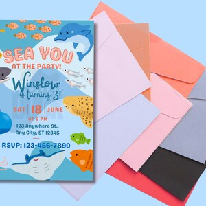 May include: An invitation with a sea theme. The invitation has a blue background with illustrations of sea creatures such as a seahorse, shark, dolphin, and fish. The text reads 'SEA YOU AT THE PARTY! Winslow is turning 3! SAT 18 JUNE AT 2 PM 123 Anywhere St., Any City, ST 12345 RSVP: 123-456-7890'. Several colorful envelopes are in the background.

Ocean Birthday Invitation - Editable Canva Template - 5x7 Under the Sea Birthday Invite