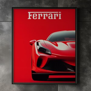 Puede incluir: Un póster enmarcado con un coche deportivo Ferrari rojo sobre un fondo rojo. El logotipo de Ferrari se muestra en blanco en la parte superior. La imagen está ambientada en un salón moderno con una silla negra, un sofá blanco y una pequeña mesa auxiliar.