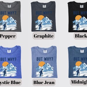 May include: Six different t-shirts in various colors, each featuring the phrase "BUT WHY?" above a graphic of a penguin, mountains, and a sun. Colors include pepper, graphite, black, mystic blue, blue jean, and midnight.