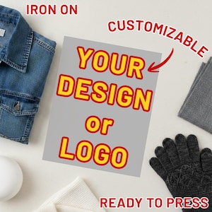 May include: A gray iron-on transfer with the text "YOUR DESIGN or LOGO" in yellow and red. The words "CUSTOMIZABLE", "READY TO PRESS", and "IRON ON" are also visible. The transfer is surrounded by a denim jacket, gloves, and other items.