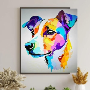 May include: A framed, colourful pop art style portrait of a dog. The dog's face is rendered in a mosaic of vibrant colours including blue, purple, yellow, orange, and white. The artwork is set against a light grey background.