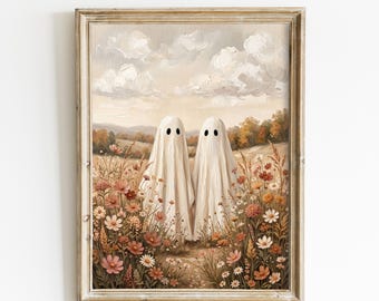 May include: A framed wall art print depicting two white ghost figures standing in a field of wildflowers under a cloudy sky. The scene features a palette of muted earth tones, including shades of beige, brown, and soft pink, within a wooden frame.