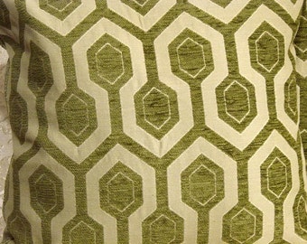 May include: A green and white geometric patterned throw pillow with a textured fabric.