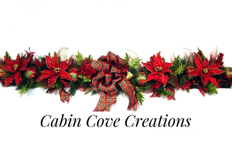 May include: A festive Christmas garland with red poinsettia flowers, green foliage, red and gold ornaments, and a plaid bow. The garland is perfect for decorating a mantel, doorway, or table for the holiday season.