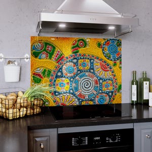 May include: A colorful kitchen backsplash featuring a mosaic turtle design. The artwork showcases a turtle with intricate patterns in shades of blue, green, red, and yellow. The backsplash is installed above a black stovetop, adding a vibrant touch to the kitchen.
