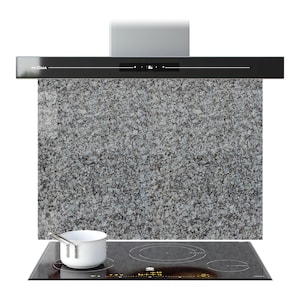 May include: A contemporary kitchen setup with a black hob featuring circular heating zones, a white saucepan, and a black extractor hood branded "PRISMA". The backdrop is a grey granite-effect splashback.