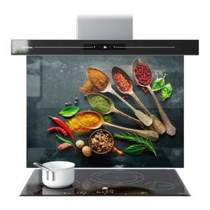 May include: A contemporary black kitchen extractor hood with a glass panel displaying an image of spices in spoons. The image shows various spices, herbs, and a small white saucepan on a black hob.