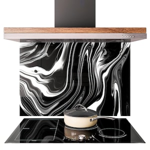 May include: A modern kitchen range hood with a black and white marble-patterned backsplash. The hood has a wooden trim and a black vent. A black glass cooktop and a cream-colored pot with a lid are in the foreground.