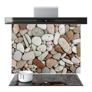 May include: A contemporary kitchen extractor fan in black, with a digital display. The splashback features a pebble stone design. A white saucepan is on a black induction hob.