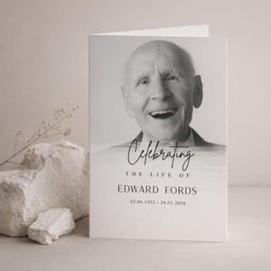 May include: A black and white memorial card featuring a smiling older man. The card reads "Celebrating the Life of Edward Fords" with the dates 02.06.1952 - 24.01.2026. The card is open and standing upright.