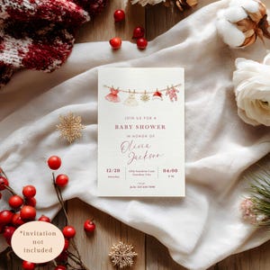 May include: Baby shower invitation with watercolor illustrations of baby clothes hanging on a clothesline. The invitation text reads "Join us for a Baby Shower in Honor of Olivia Jackson" with date, time, and RSVP information.