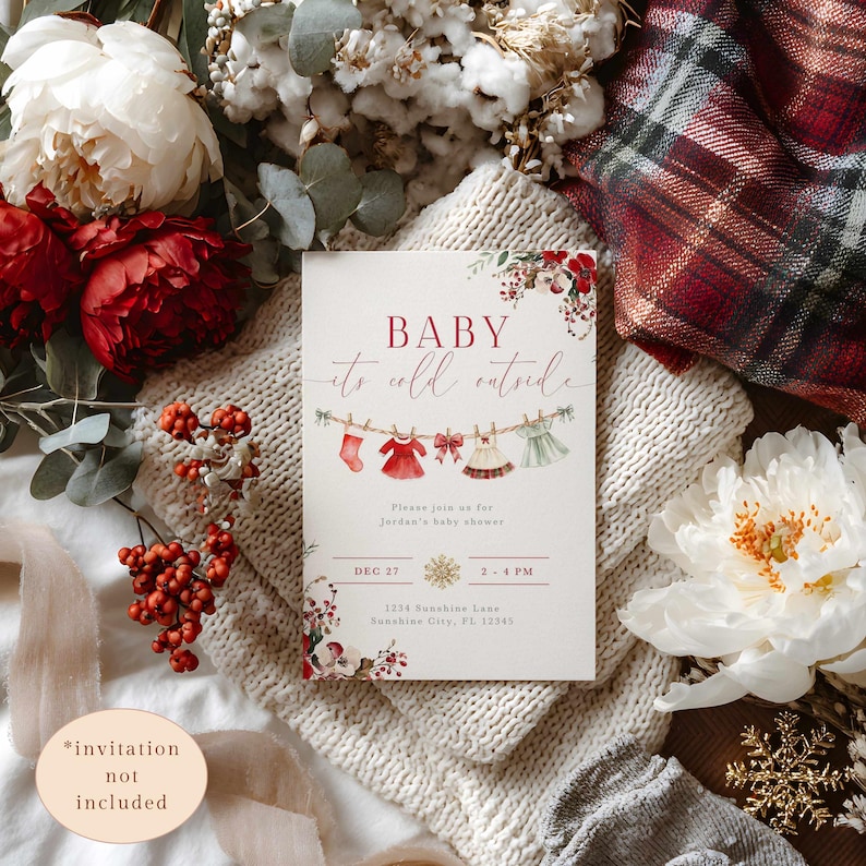 May include: A baby shower invitation with the text "BABY it's cold outside." The invitation features illustrations of baby clothes hanging on a clothesline. The design includes floral accents and the date and time of the shower.