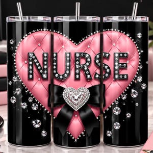 May include: A black cylindrical tumbler with a straw, featuring a large pink tufted heart design. The word NURSE is printed in black letters outlined with faux diamonds. A black bow and a smaller heart-shaped diamond accent are centered below.