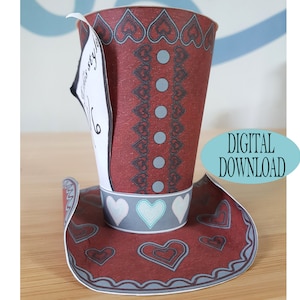 May include: Red and white paper hat with a heart pattern and a white tag that says "Mad Hatter Style".