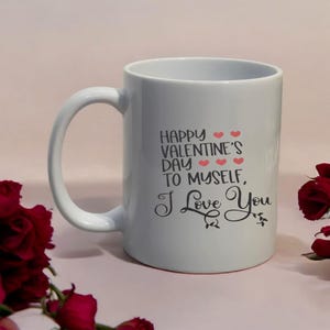 May include: White ceramic mug with a curved handle. The mug features the text "HAPPY VALENTINE'S DAY TO MYSELF, I Love You" in black script with red heart accents. The mug is set against a light pink background.