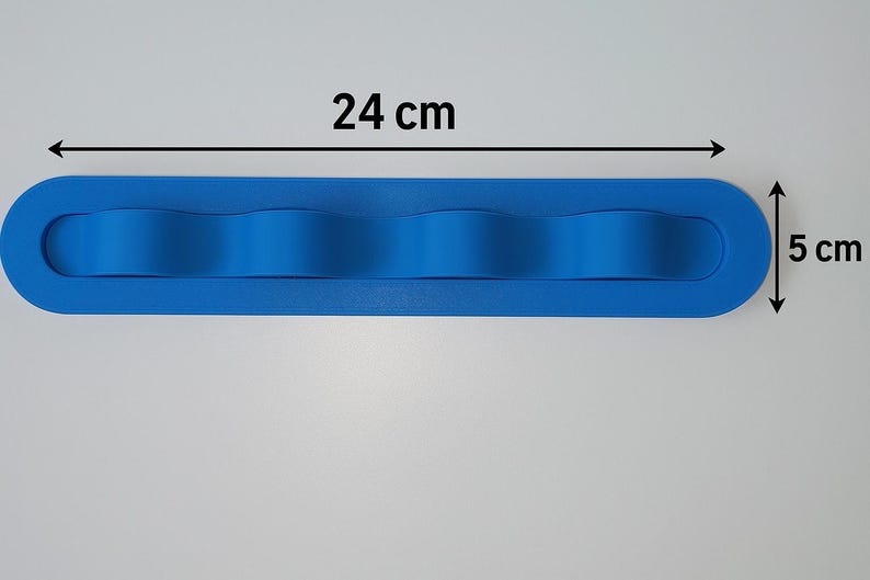 May include: A bright blue, elongated, oval-shaped silicone organizer with four rounded, wave-like dividers. The object measures 24 cm in length and 5 cm in width, as indicated by the black text and arrows printed directly on the image.