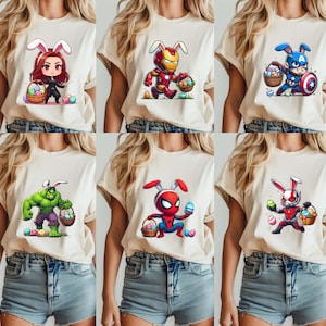 May include: A collection of six beige t-shirts featuring cartoon characters with bunny ears and Easter baskets. Characters include Black Widow, Iron Man, Captain America, Hulk, Spider-Man, and Ant-Man. Each design has colorful Easter eggs.