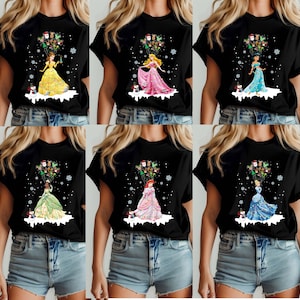 This Disney Princess Christmas shirt features Ariel, Belle, Tiana, Jasmine, Cinderella, and Aurora holding festive holiday balloons. Printed on a cozy Comfort Colors® tee, it's perfect for family trips, group matching, or magical holiday gifts for Disney fans.