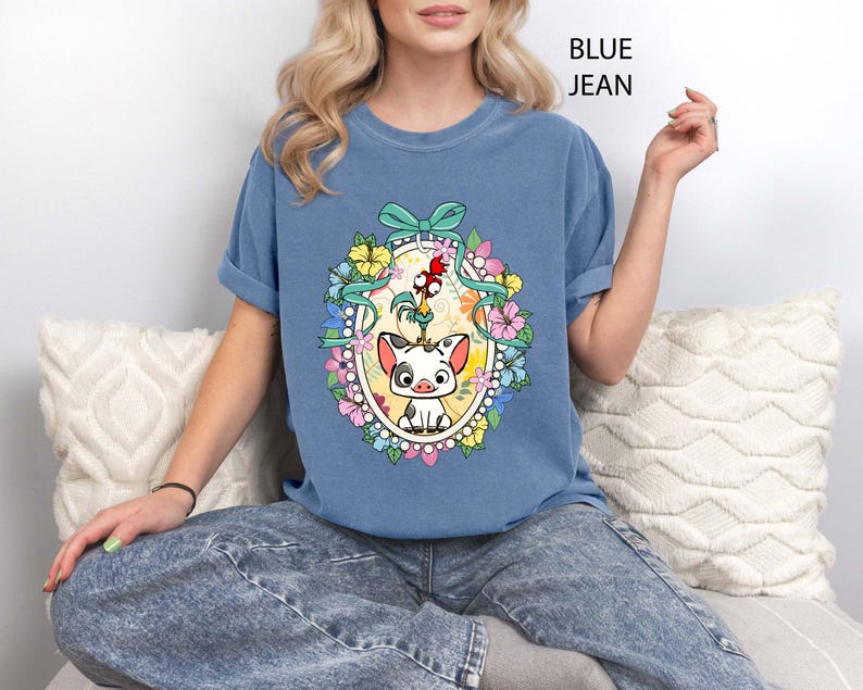 Celebrate Disney magic with our Floral Hei Hei Pua Coquette Bow Shirt featuring adorable Moana characters with a feminine twist. This Comfort Colors® tee showcases Hei Hei and Pua surrounded by floral accents and a cute coquette bow, making it perfect for Disney fans. Great for Disney World trips, Disneyland vacations, or everyday Disney love. A charming and trendy tee for girls trips, family vacations, or Moana lovers of all ages.