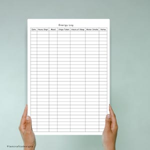 May include: A white paper energy log tracker with black grid lines and headers for Date, Hours Slept, Mood, Steps Taken, Hours of Sleep, Water Intake, and Notes. The document features a clean, organized layout for daily health and wellness tracking.