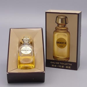 May include: A bottle of Givenchy III Eau de Toilette perfume in its original box. The perfume bottle is clear glass with a gold cap. The box is brown with the perfume name and volume information.