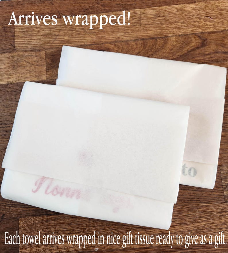 May include: Two white tissue paper wrapped towels. The text "Arrives wrapped!" is at the top of the image. The text "to" is visible on one towel and the text "I love" is visible on the other towel. The text "Each towel arrives wrapped in nice gift tissue ready to give as a gift." is at the bottom of the image.
