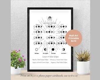 May include: A framed black and white 2026 Lunar Calendar print. The calendar displays moon phases and eclipse dates. The print is labeled "Wall Art Printable 8x10" and is printed on 8.5 x 11 photo paper cardstock, cut to 8 x 10.