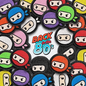 May include: A collection of colorful ninja patches with black borders. The patches feature various colors, including red, green, purple, and blue, with a ninja face design. The phrase "BACK to the 80's" is in the center.