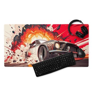 May include: A rectangular desk mat featuring a stylized illustration of a classic car in an explosion. The mat has a red and white background with a black keyboard, mouse, and headphones.