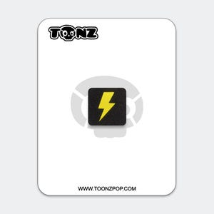 May include: A square black patch featuring a yellow lightning bolt icon, centered on a white backing card. The card displays the text TONZ at the top and WWW.TOONZPOP.COM at the bottom, with a faint gray skull graphic behind the patch.