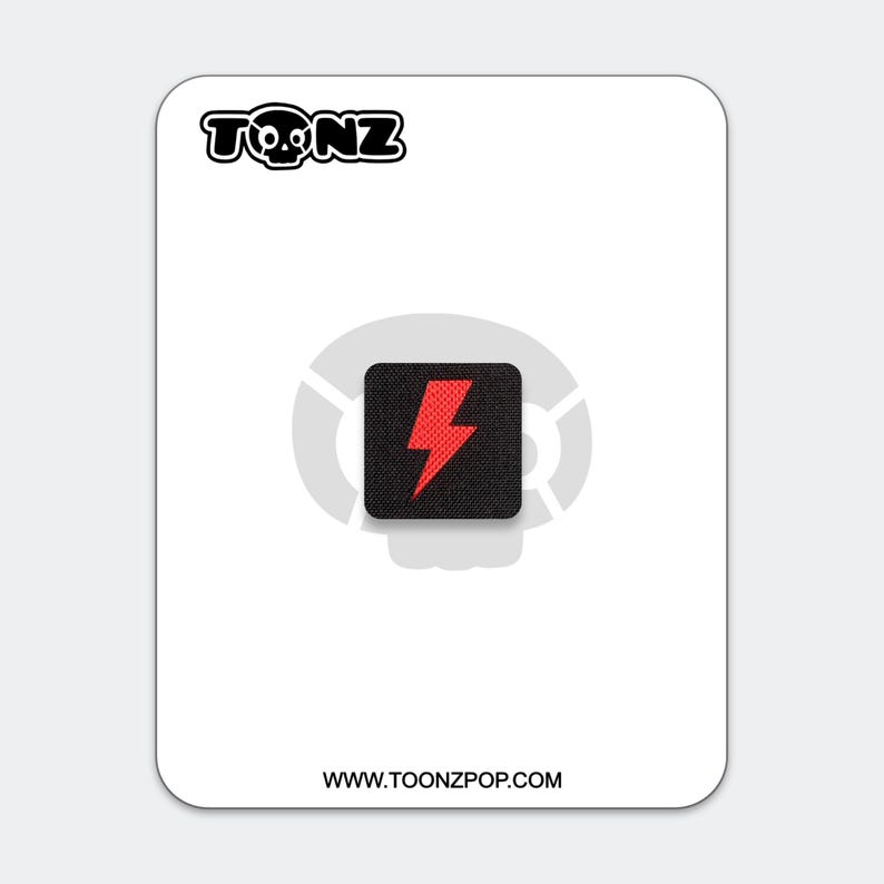 May include: A square black patch featuring a red lightning bolt graphic centered on a white backing card. The card displays the text TONZ at the top with a skull icon and the website URL WWW.TOONZPOP.COM at the bottom, with a faint skull logo.